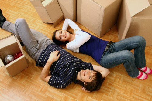Local movers handling boxes and furniture in East London